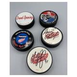 Detroit redwings hockey pucks some signed,