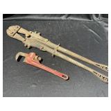 Bolt cutters and pipe wrench.