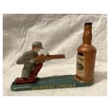 A cast iron Southern Comfort mechanical coin