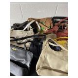 Assortment of a new and used purses