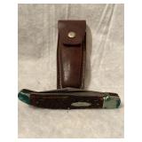 9 inch folding blade knife with leather sheath.