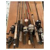 Lot of 10 fishing poles with reels a couple seem