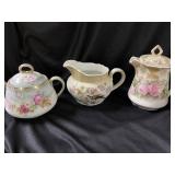 Three pieces of stamped cream sugar and teapot