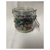 LeParfail Jar full of marble. Jar has a 4 inch