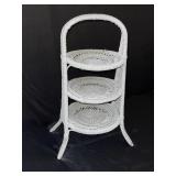 White three tiered wicker stand. Stand is 26