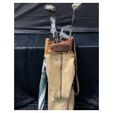 Vintage golf clubs in bag with umbrella