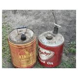 Two metal gas cans, one is a Kendall the other is