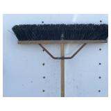 Stiff bristled push broom