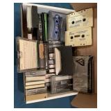 Box of cassette tapes including Proud to lLve in