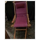 Folding wooden chair with cushions.