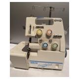 ( w) White Speedylock Sewing Machine holds 4