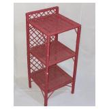 Three shelf pink wicker stand.