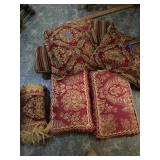 Box of red toned decorative pillows