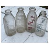 Five vintage milk jugs.