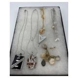 Four necklace chains with pendants