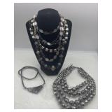 R2) Black and silver colored costume necklaces