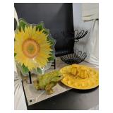 Ceramic frog, glass sunflower bowl and a fruit