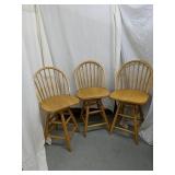 Set of three wooden swiveling bar stools
2
