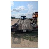 Tri axle flatbed trailer with dove tail and ramps
