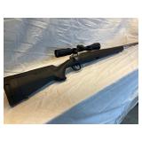 Savage Axis 223 bolt action w/ stainless steele black stock acc trigger w/ scope
