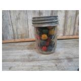 WOODEN MARBLES IN ZINC TOP JAR