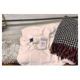 Bedding, blankets, long pillow, small rug