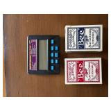 Handheld Digital Poker Game and Two Decks of Playing Cards