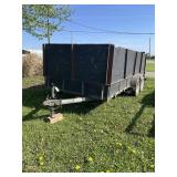 Black tandem axle utility trailer with high sides
