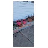 Four flower pots and hose