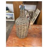 Antique glass and wicker rum jug