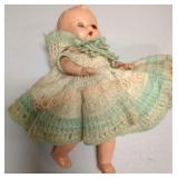 Antique baby doll with crocheted dress