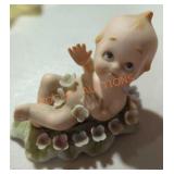 1960s Lefton Kewpie Laying in Bed of Flowers