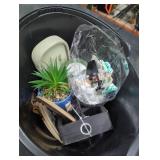 Bucket of fake plants and candles