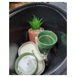Bucket full of candles and fake plants