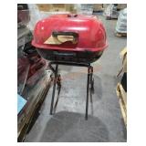 1 red charcoal grill on wheels