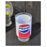 A Pepsi Glass a coke Glass and a Leo Glass cup.