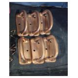 Half a dozen dull copper box handles.