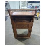 Hanging wall cabinet with mirror 15in W by 24in H.