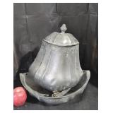 Mountable vintage pewter beverage dispenser.