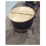 large vintage cast iron cauldron on stand.