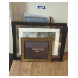 A variety of different size framed paintings and
