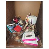 Shelf lot with camera and different accessories.