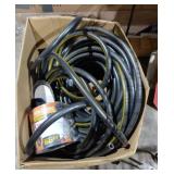 Box Lot Of Black Garden Hose And Flexible Hose.