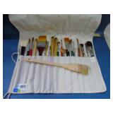 artists paint brushes in wrap holder