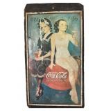 Metal Coca Cola Sign on Wood