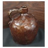 brown stoneware jug, likely an antique or vintage