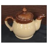 vintage ceramic teapot with a two-tone brown and