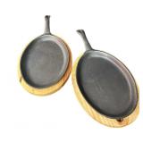 (2) Cast Iron Griddles wï¿½ Wood Bases