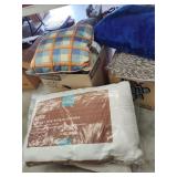 Assorted pillows and box of rugs