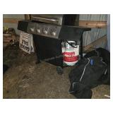 Gass grill with tank and cover.